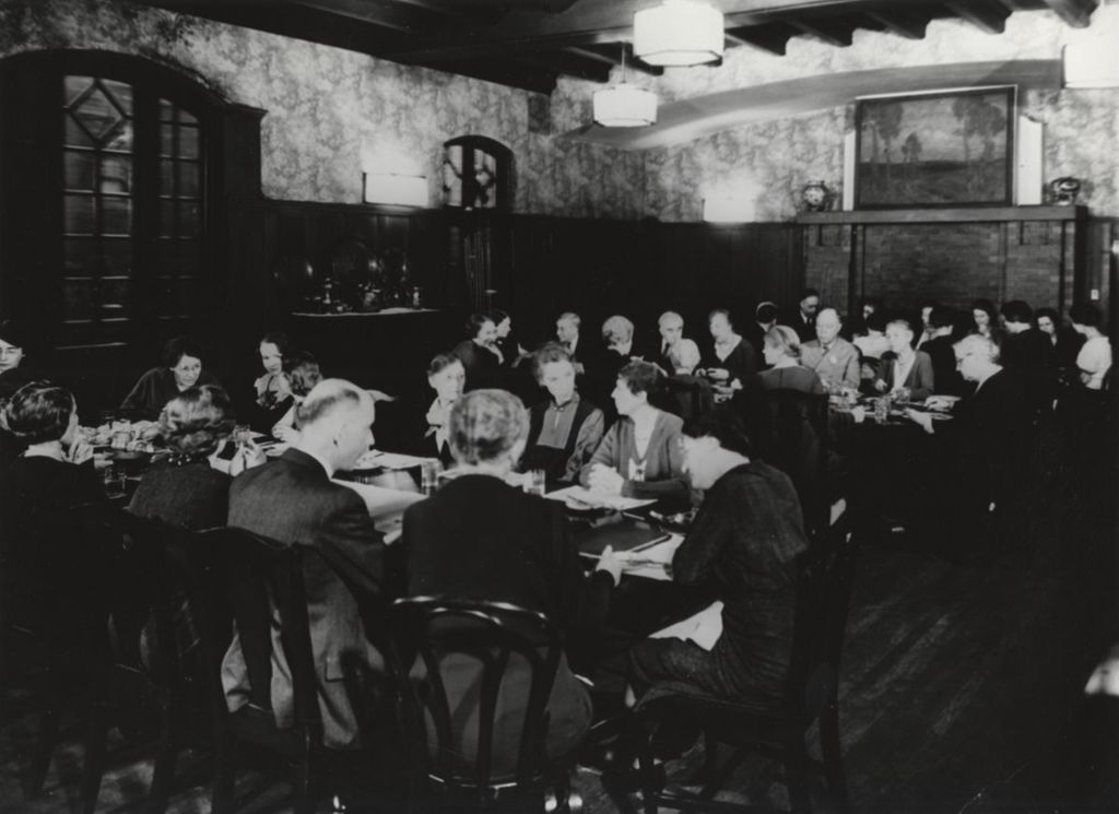 Hull-House co-founder and head resident Jane Addams and other Hull-House residents at dinner in the Residents' Dining Hall