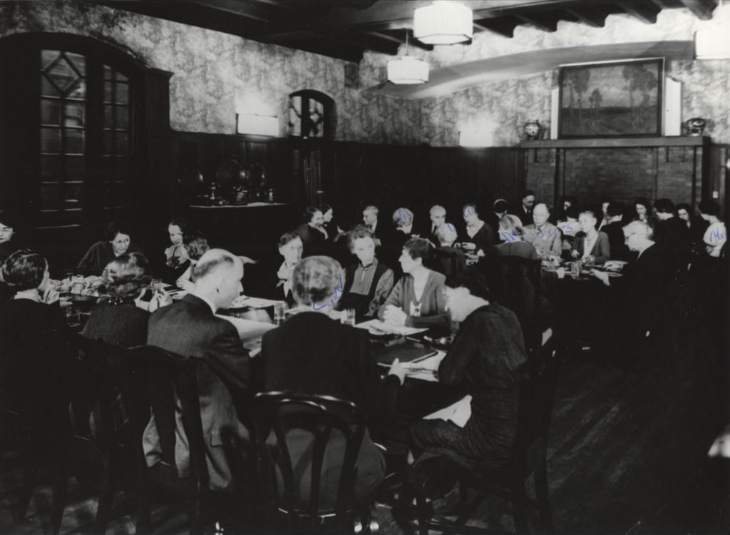 Hull-House co-founder and head resident Jane Addams and other Hull-House residents at dinner in the Residents' Dining Hall