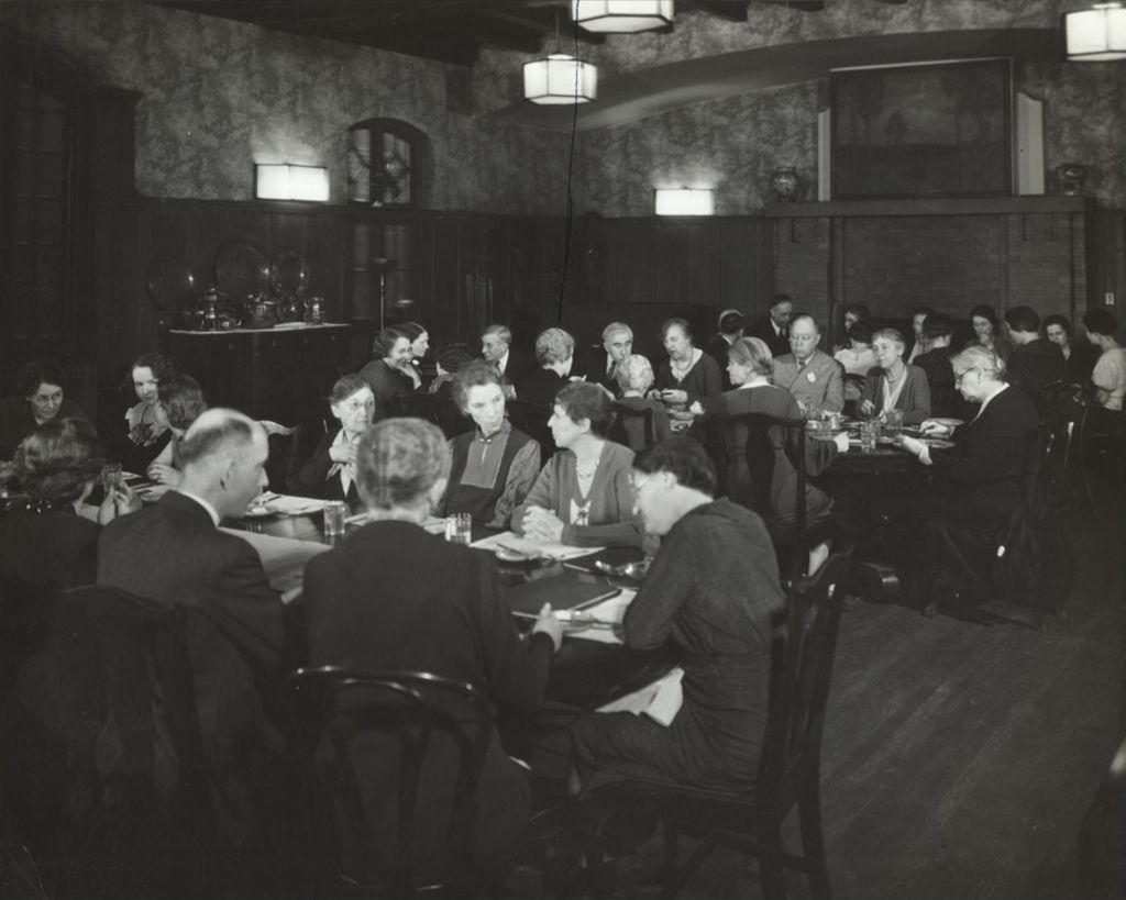 Miniature of Hull-House co-founder and head resident Jane Addams and other Hull-House residents at dinner in the Residents' Dining Hall
