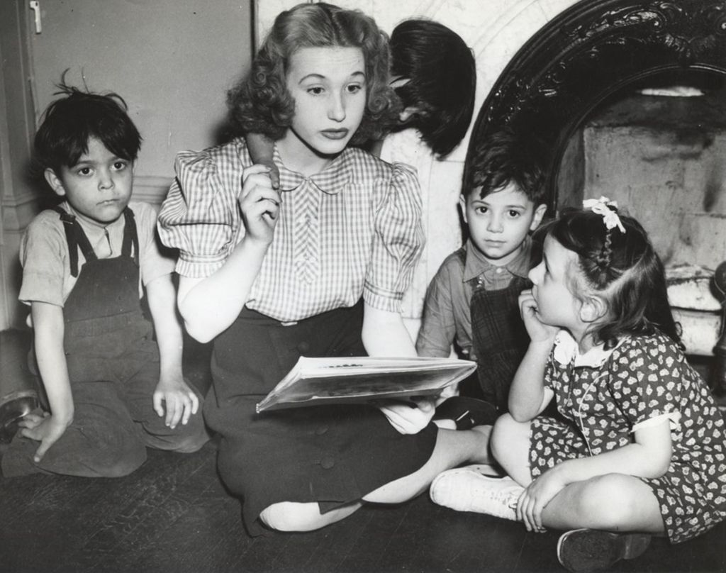 Woman and four children at story time at Hull-House