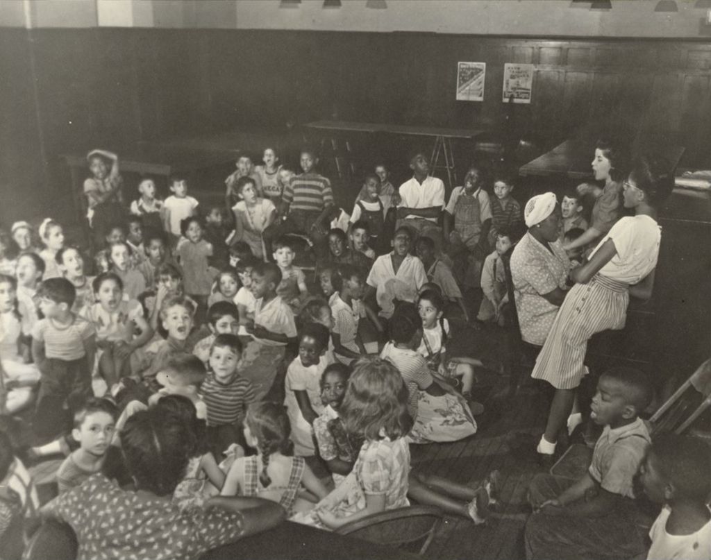 Summer play group participants singing in a large room at Hull-House