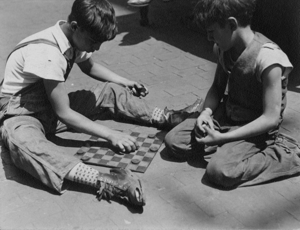 Boys playing checkers in alley behind Hull-House