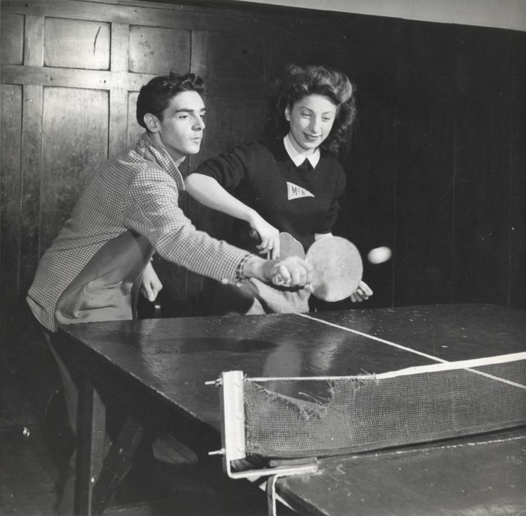 Miniature of Young man and young woman playing doubles table tennis in Hull-House game room