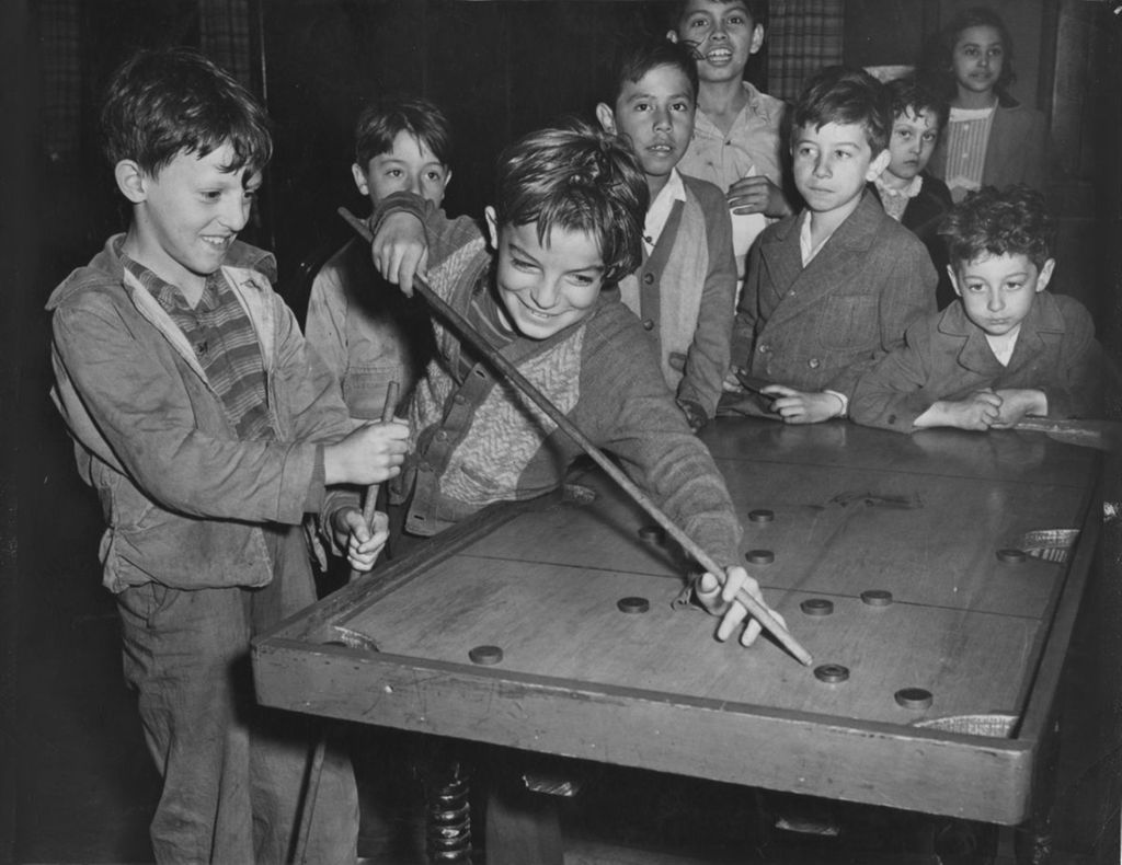 Children playing carrom in Hull-House game room