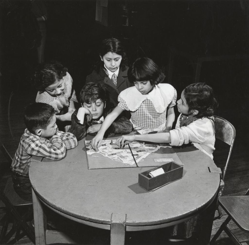 Children playing Climb the Mountain board game at Hull-House