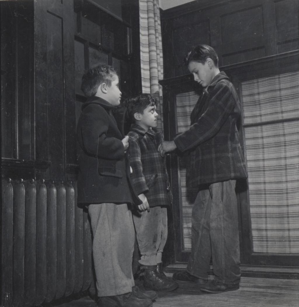 Miniature of Three boys putting on jackets at Hull-House