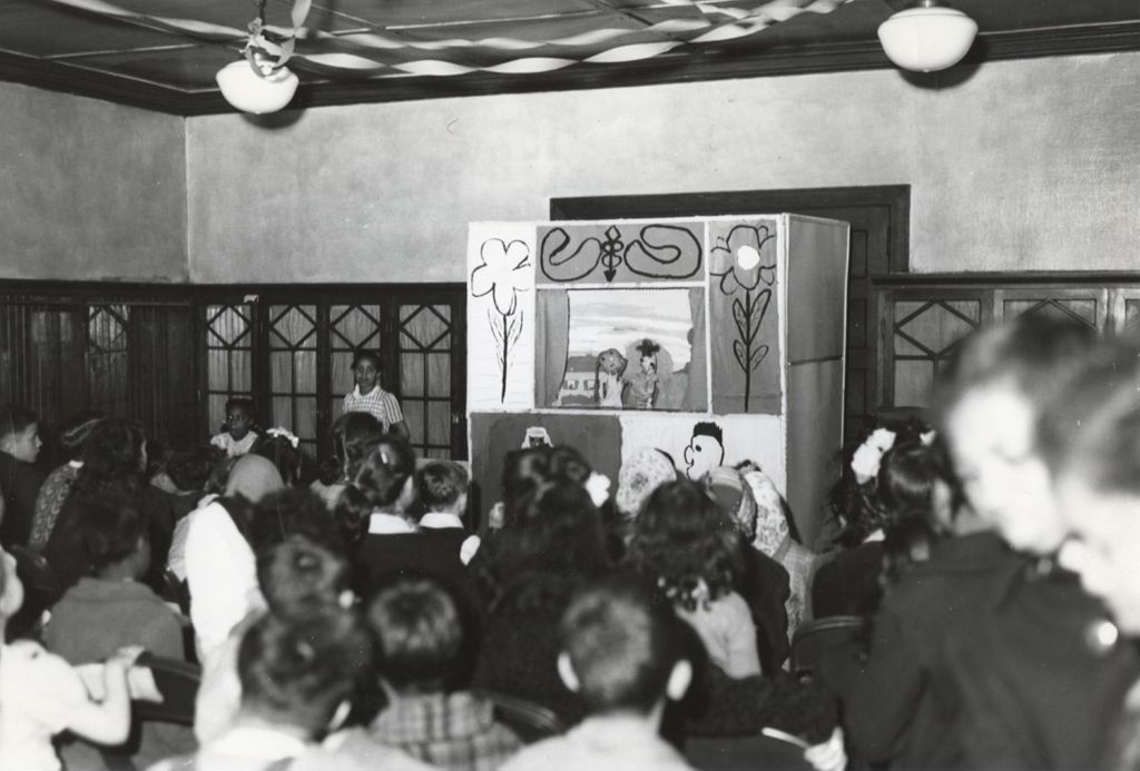 Miniature of Children watch a puppet show at Hull-House