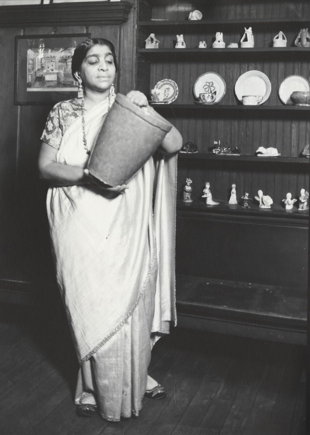 Miniature of Indian poet and independence leader Sarojini Naidu holding a large ceramic jar at Hull-House