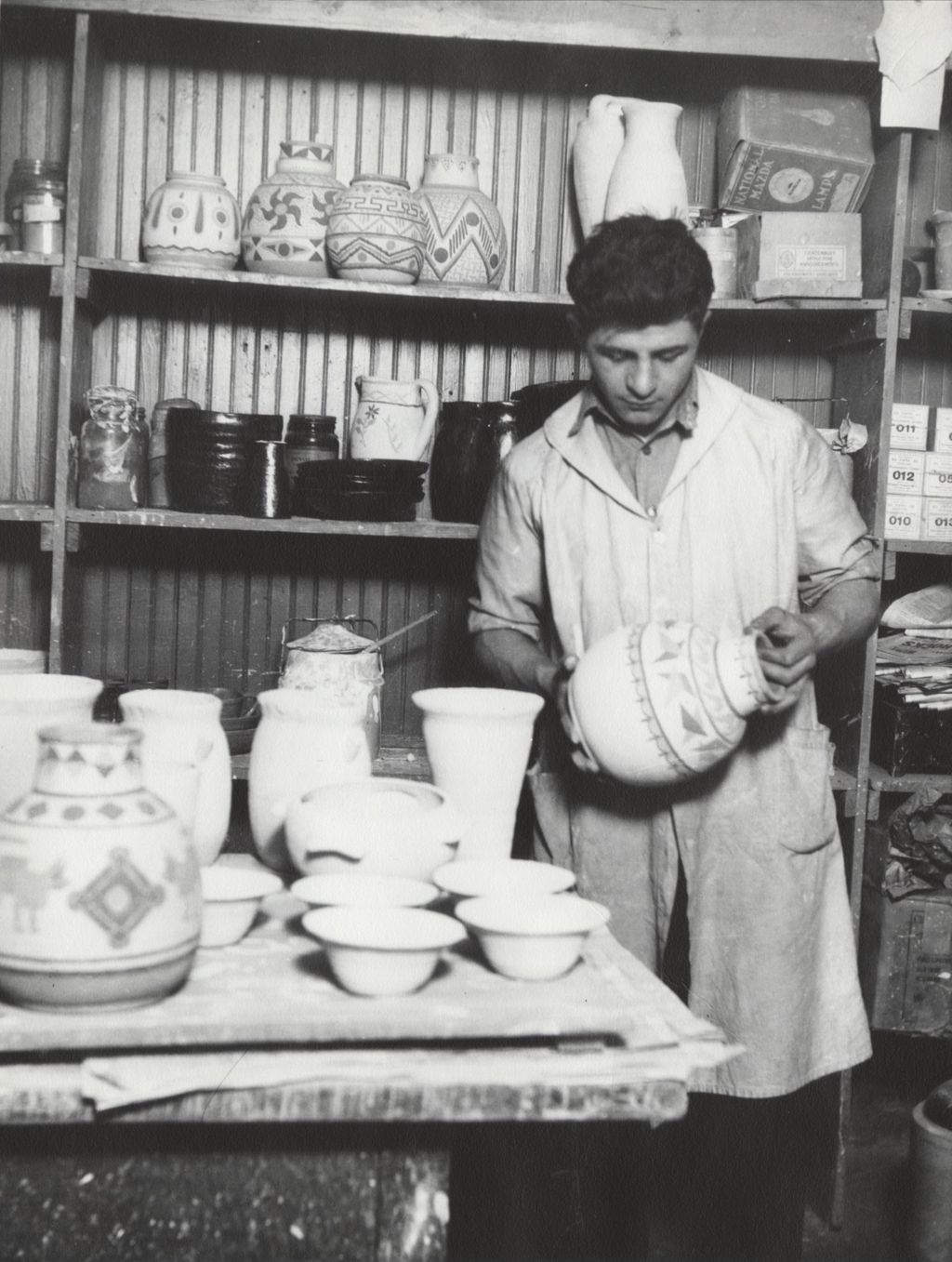 Foreman of Hull-House Kilns Nick Fosco holding a ceramic vase