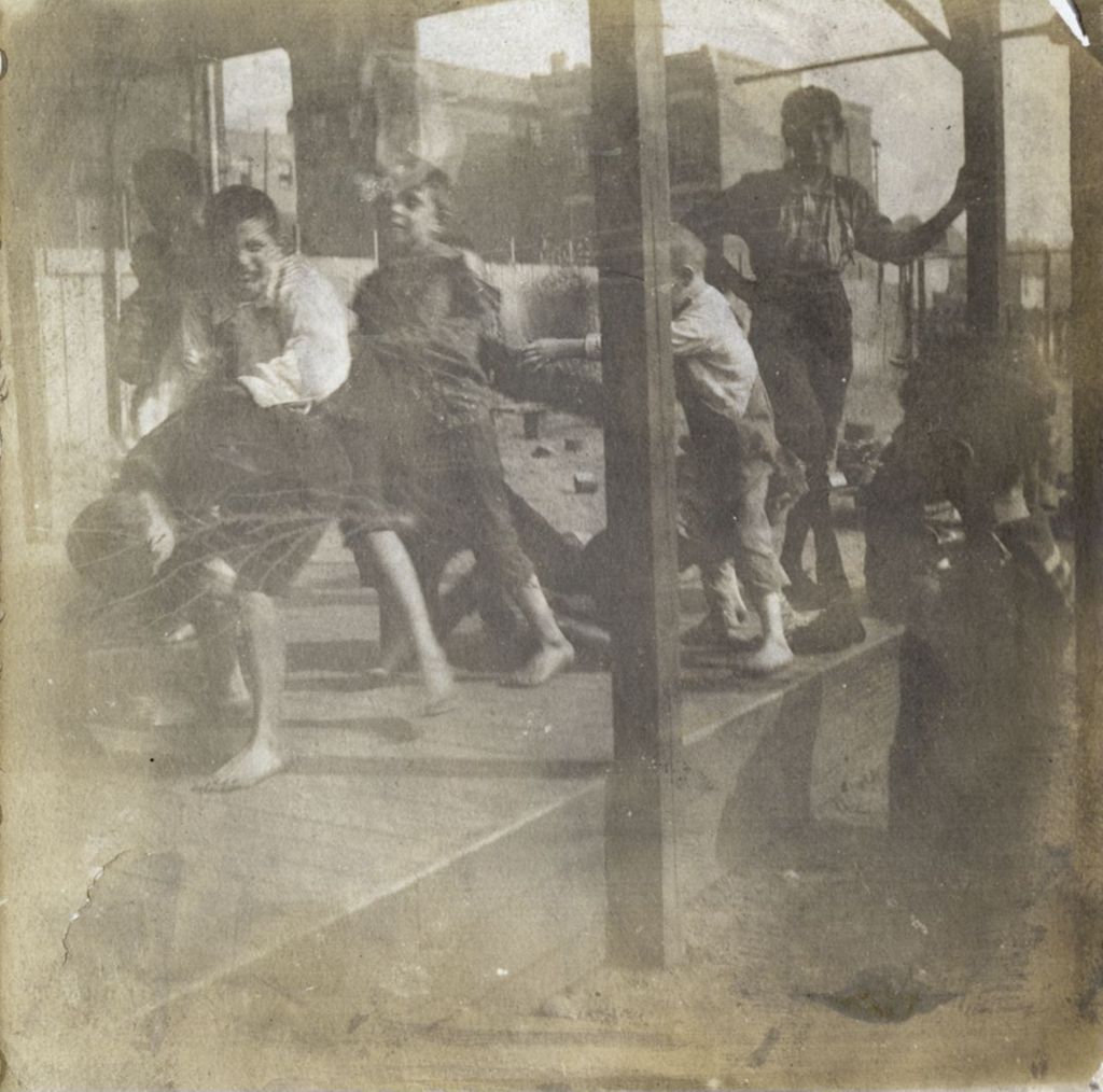 Miniature of Boys playing leapfrog at Hull-House playground covered pavilion