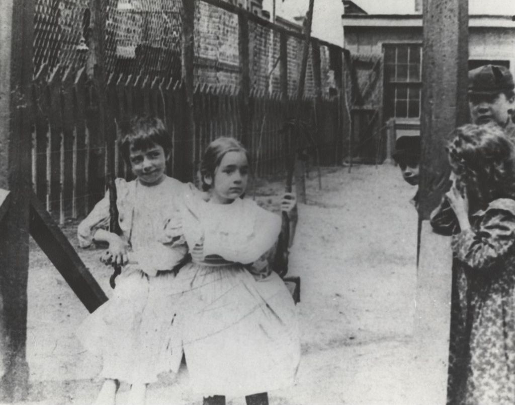 Miniature of Two girls sitting on swing at Hull-House playground