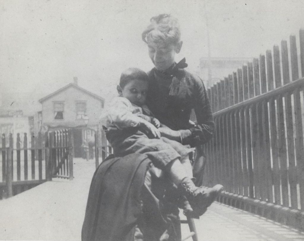 Hull-House co-founder Ellen Gates Starr sitting outside with a young boy on her lap