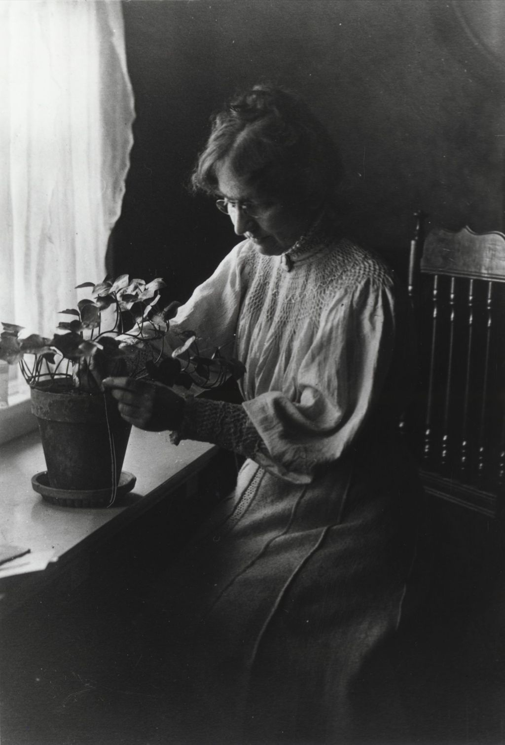 Miniature of Hull-House co-founder Ellen Gates Starr repotting a plant