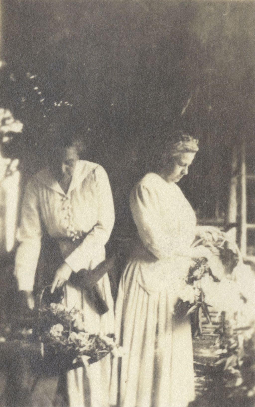 Miniature of Mary Rozet Smith and Louise De Koven Bowen holding baskets of flowers at Bowen Country Club