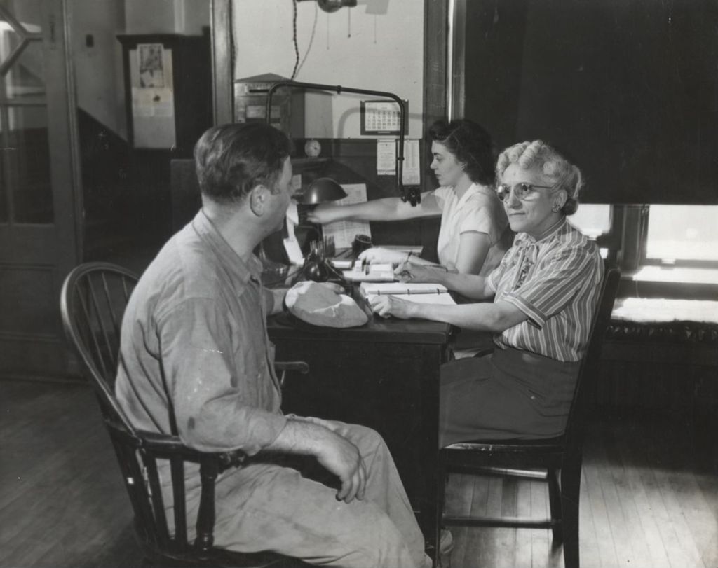 Miniature of Hull-House employees Spiro Patsios, Camille Ippolito, and Frances Molinaro sitting at desks