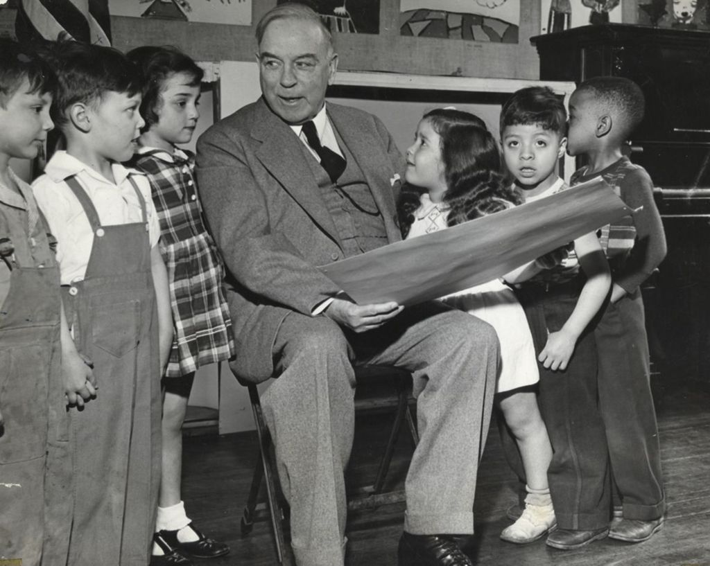 Canadian Prime Minister and former Hull-House resident W. L. Mackenzie King engaging with six children at Hull-House