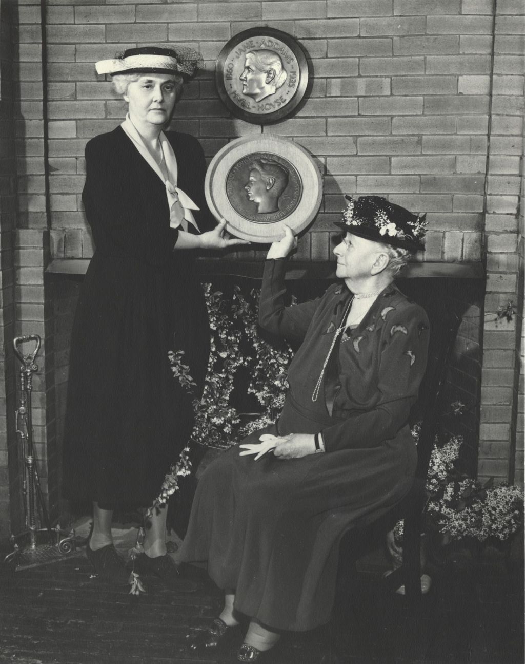 Louise de Koven Bowen and Hull-House board president Alma Petersen holding a bas relief plaque in Bowen's honor during the 1949 Hull-House Associates Dinner