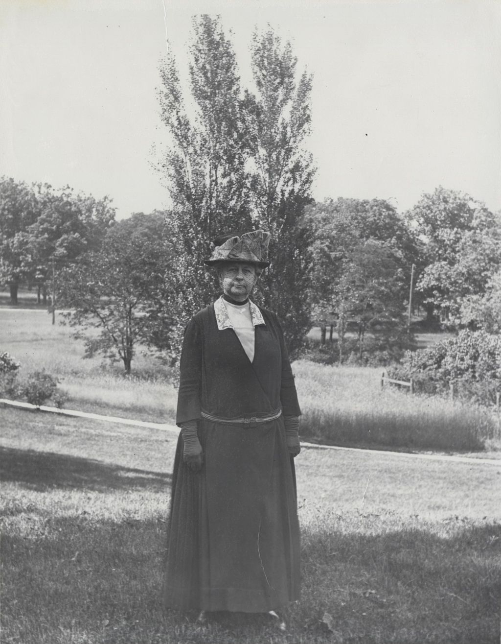 Miniature of Louise de Koven Bowen standing in a field at Bowen Country Club