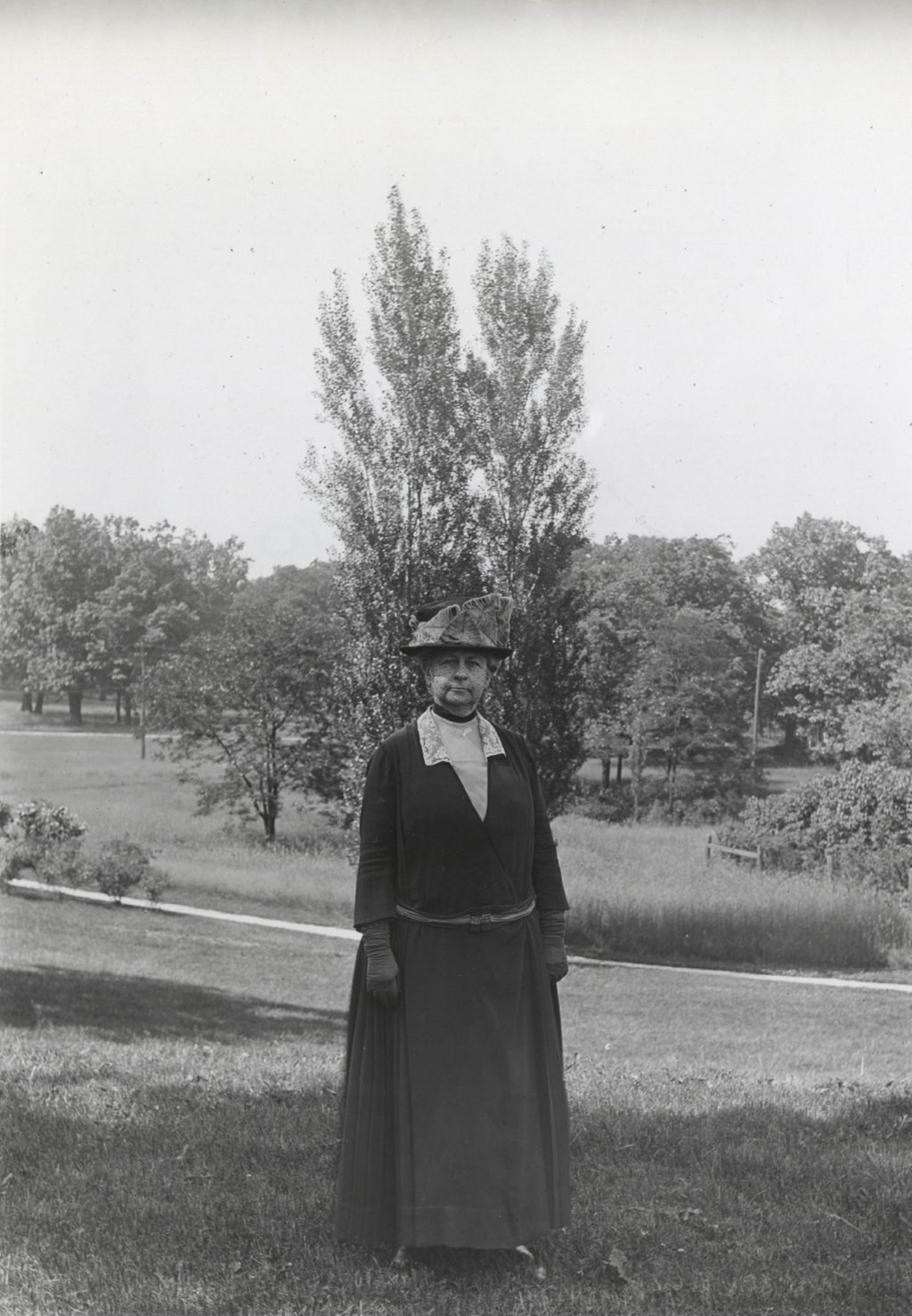 Miniature of Louise de Koven Bowen standing in a field at Bowen Country Club