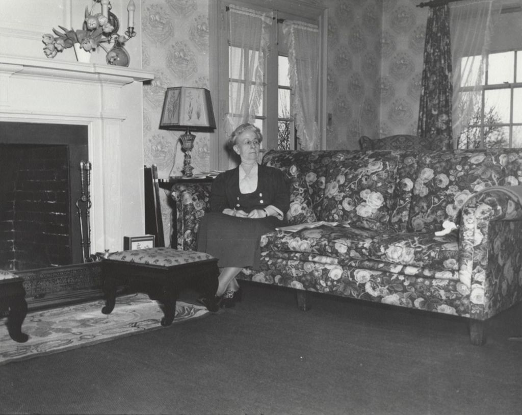 Miniature of Louise de Koven Bowen sitting on a couch in her cottage at Bowen Country Club