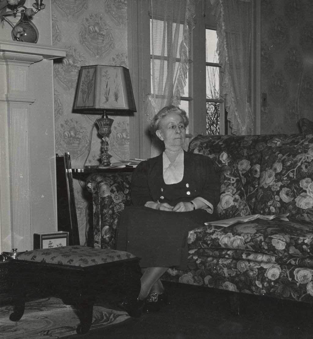 Miniature of Louise de Koven Bowen sitting on a couch in her cottage at Bowen Country Club