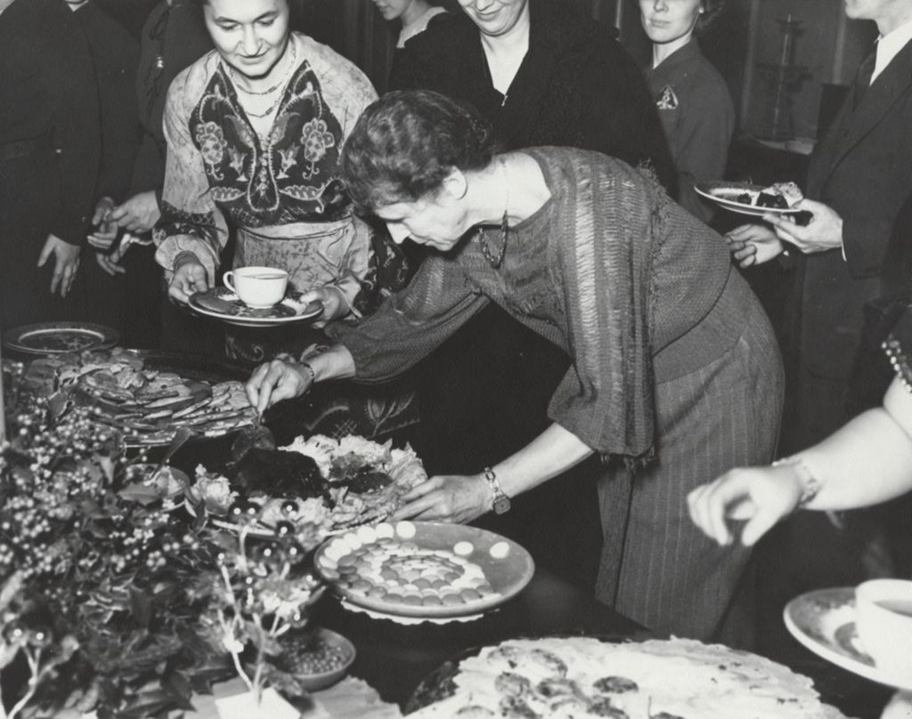Hull-House resident Jessie Binford at a banquet buffet table
