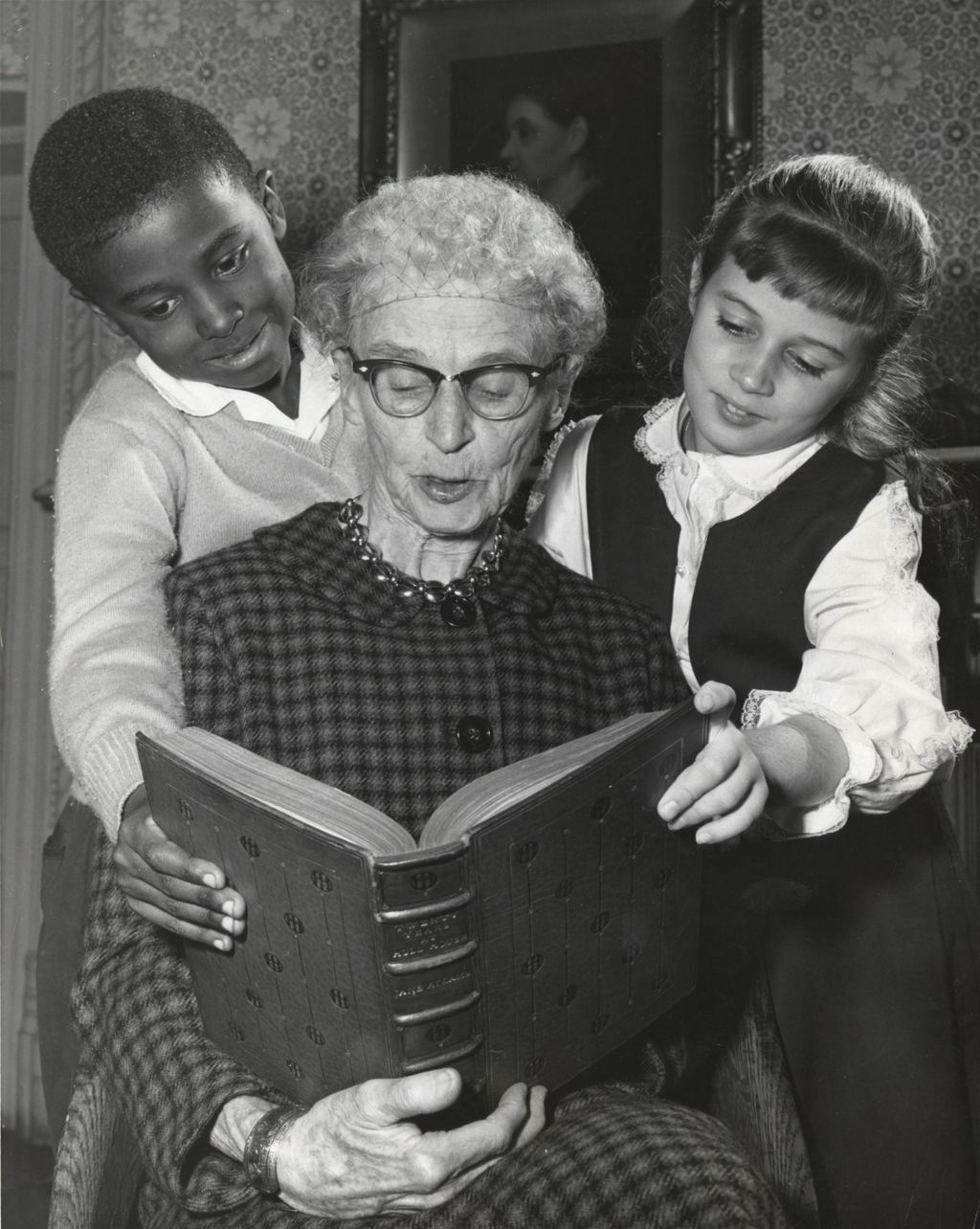 Miniature of Hull-House resident Jessie Binford reading to two children