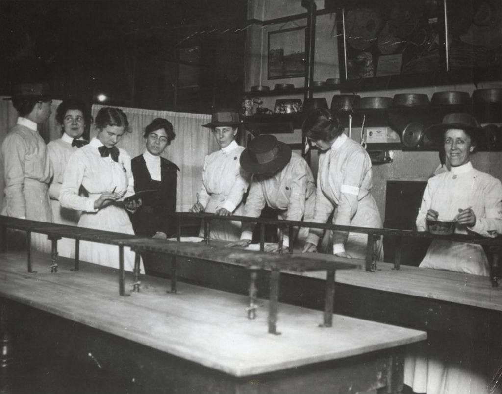 Miniature of Members of the Visiting Nurse Association in Hull-House domestic science room demonstrating a new formula