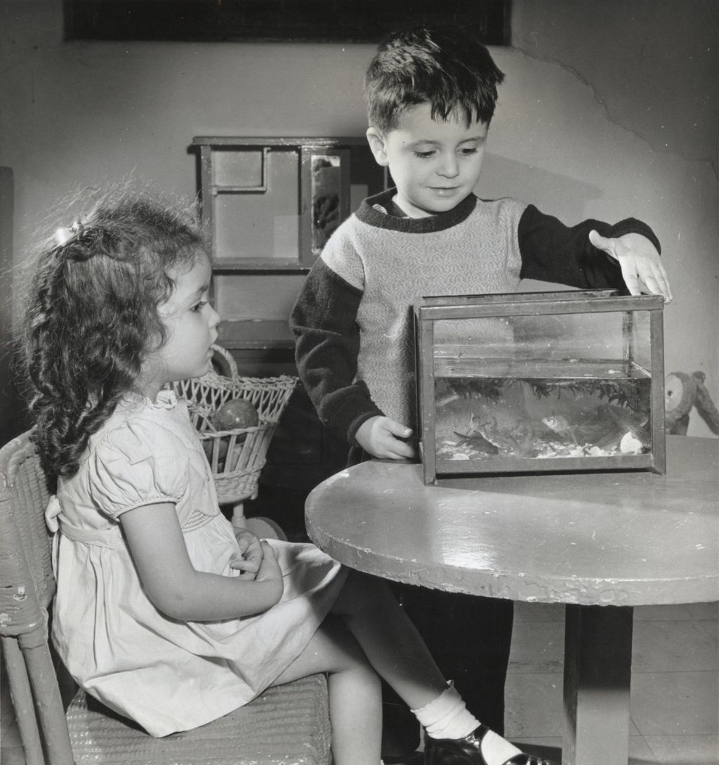 Two children with an aquarium