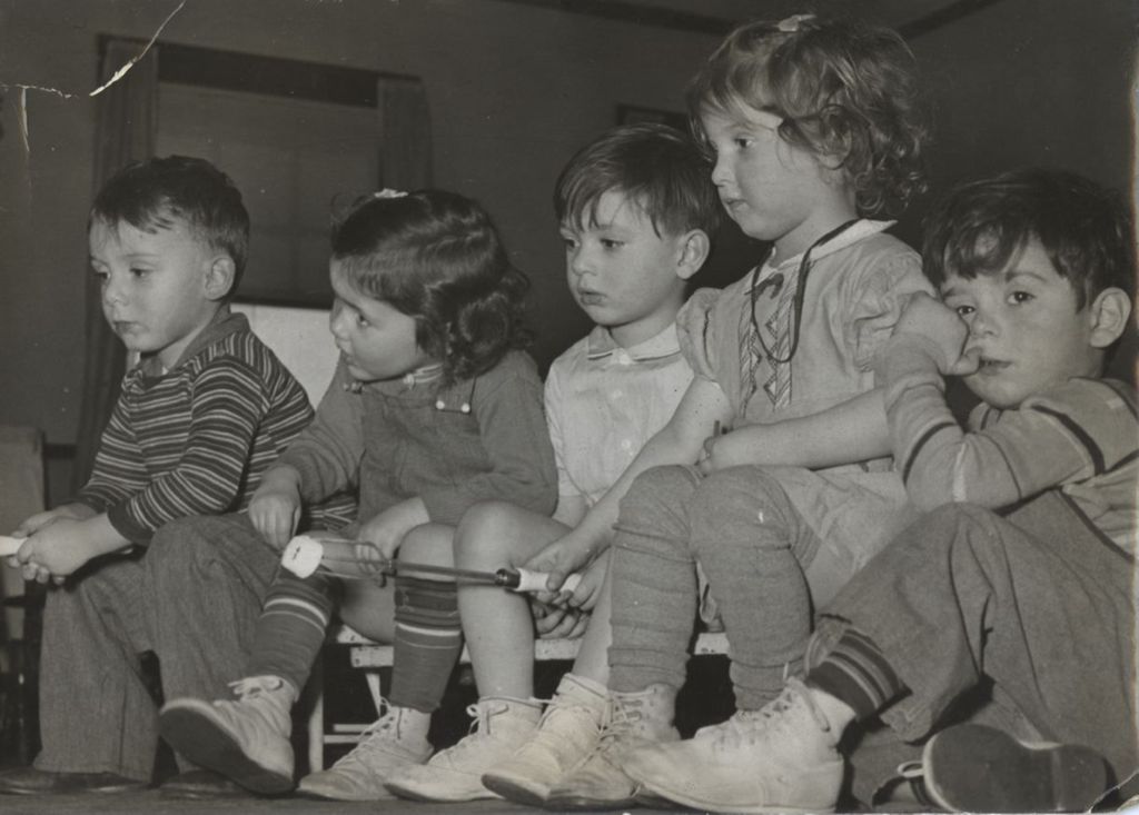Five children at Mary Crane Nursery, two roasting marshmallows