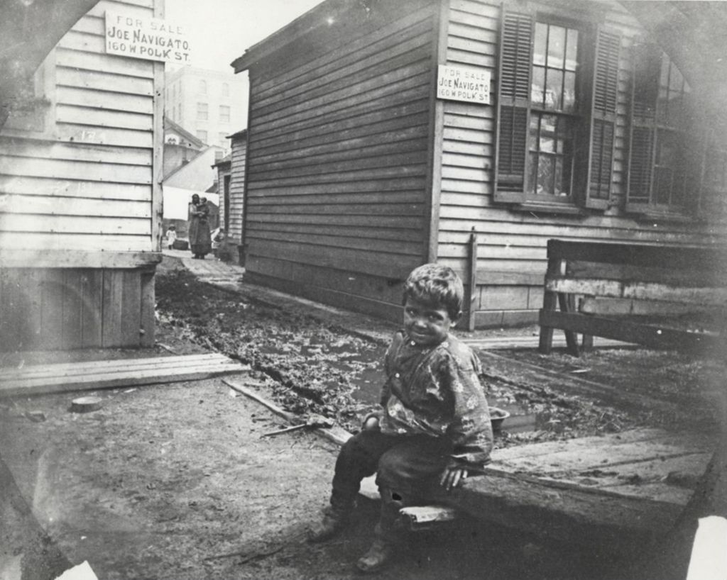 Miniature of Boy sitting on wooden ramp in neighborhood near Hull-House