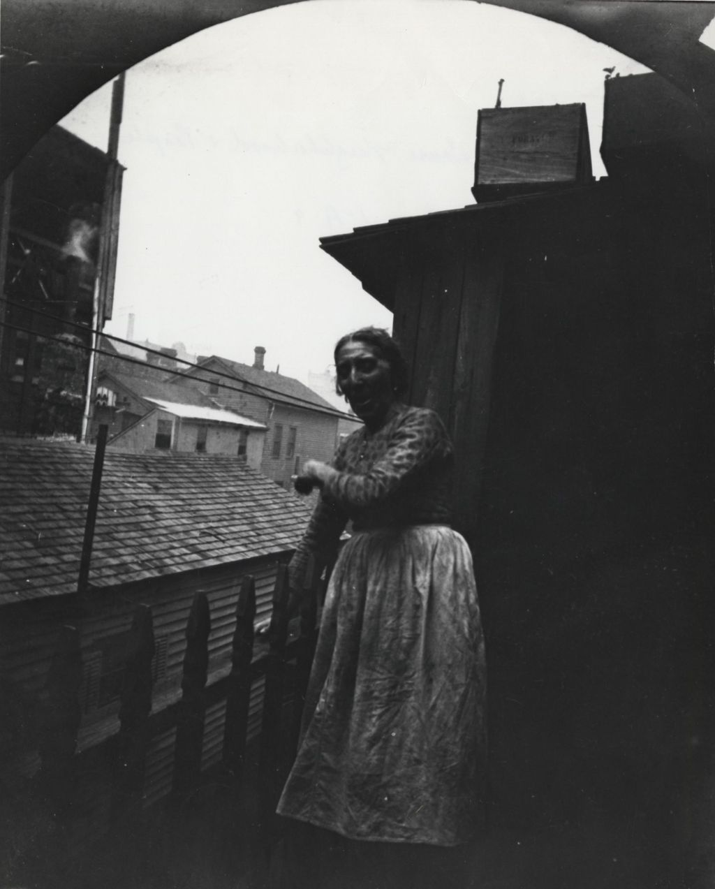 Miniature of Woman standing on a balcony in neighborhood near Hull-House