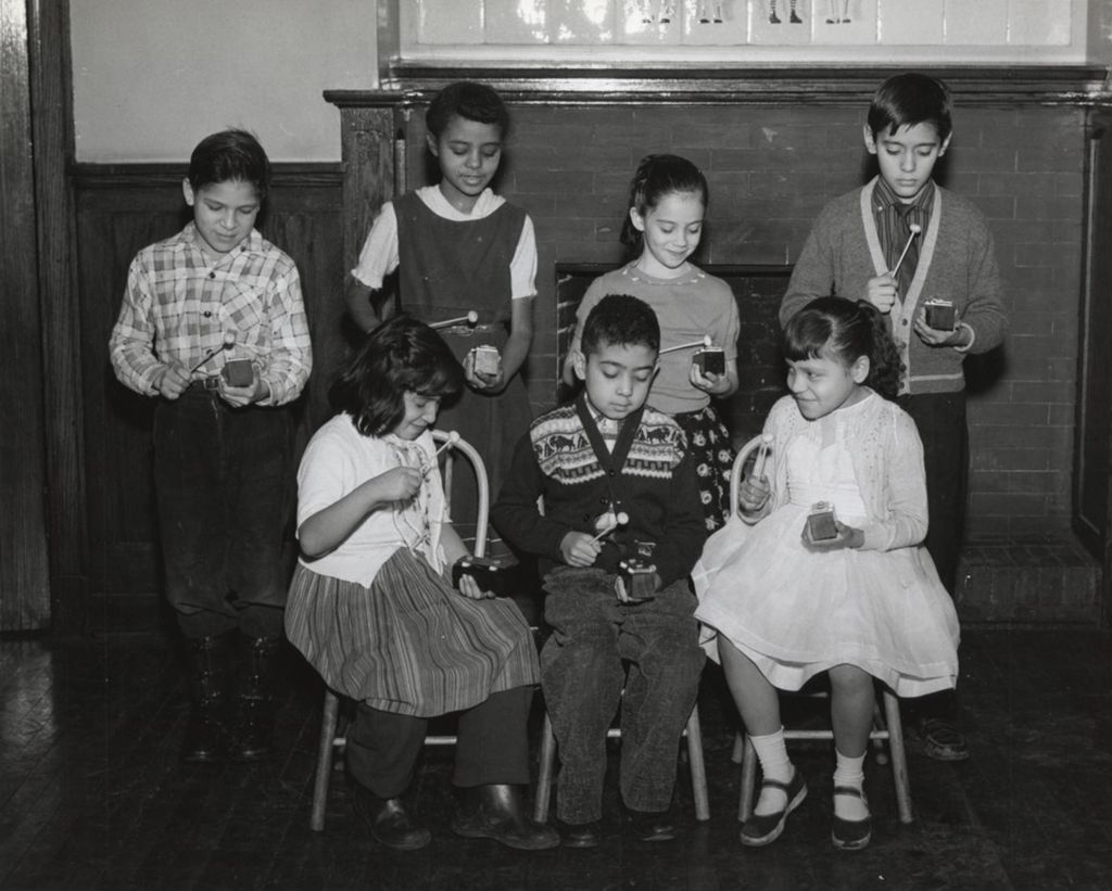 Children playing wood block-type instruments at Hull-House Music School