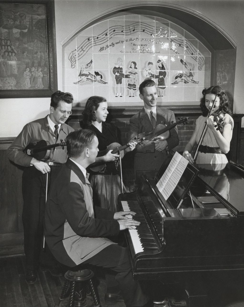 Young woman playing violin as four other musicians look on