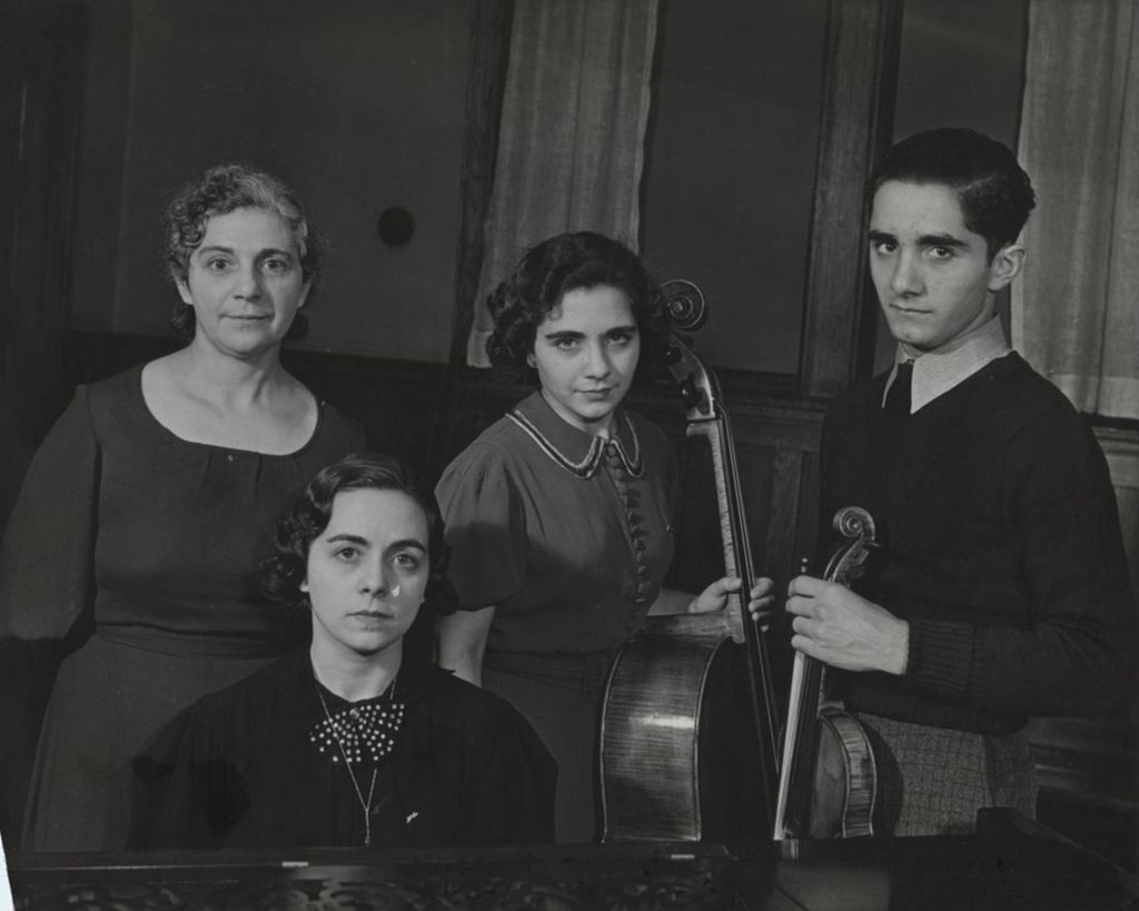 Four members of the Adezio family posing at Hull-House Music School