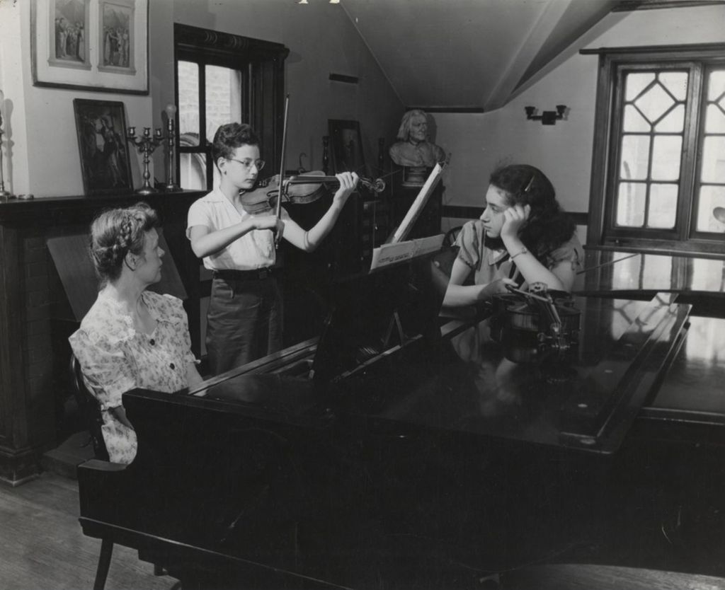 Miniature of Violinist and pianist playing at Hull-House Music School while violinist Nesta Smith observes