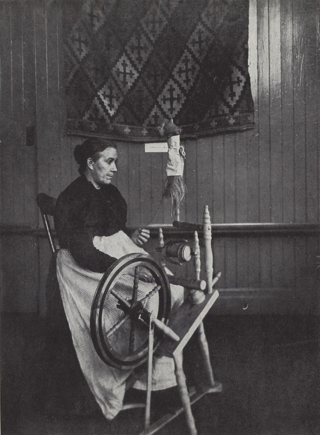 Miniature of Woman demonstrating Irish spinning technique at Hull-House Labor Museum