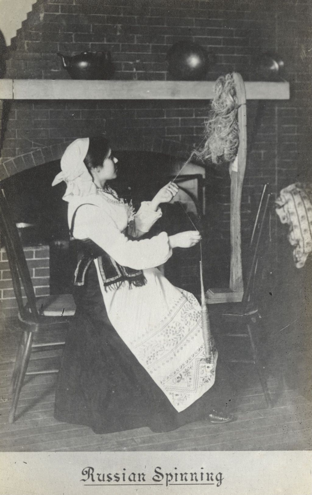 Miniature of Postcard of woman demonstrating "Russian Spinning" at Hull-House Labor Museum