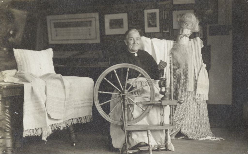 Miniature of Postcard of woman sitting at spinning wheel at Hull-House Labor Museum