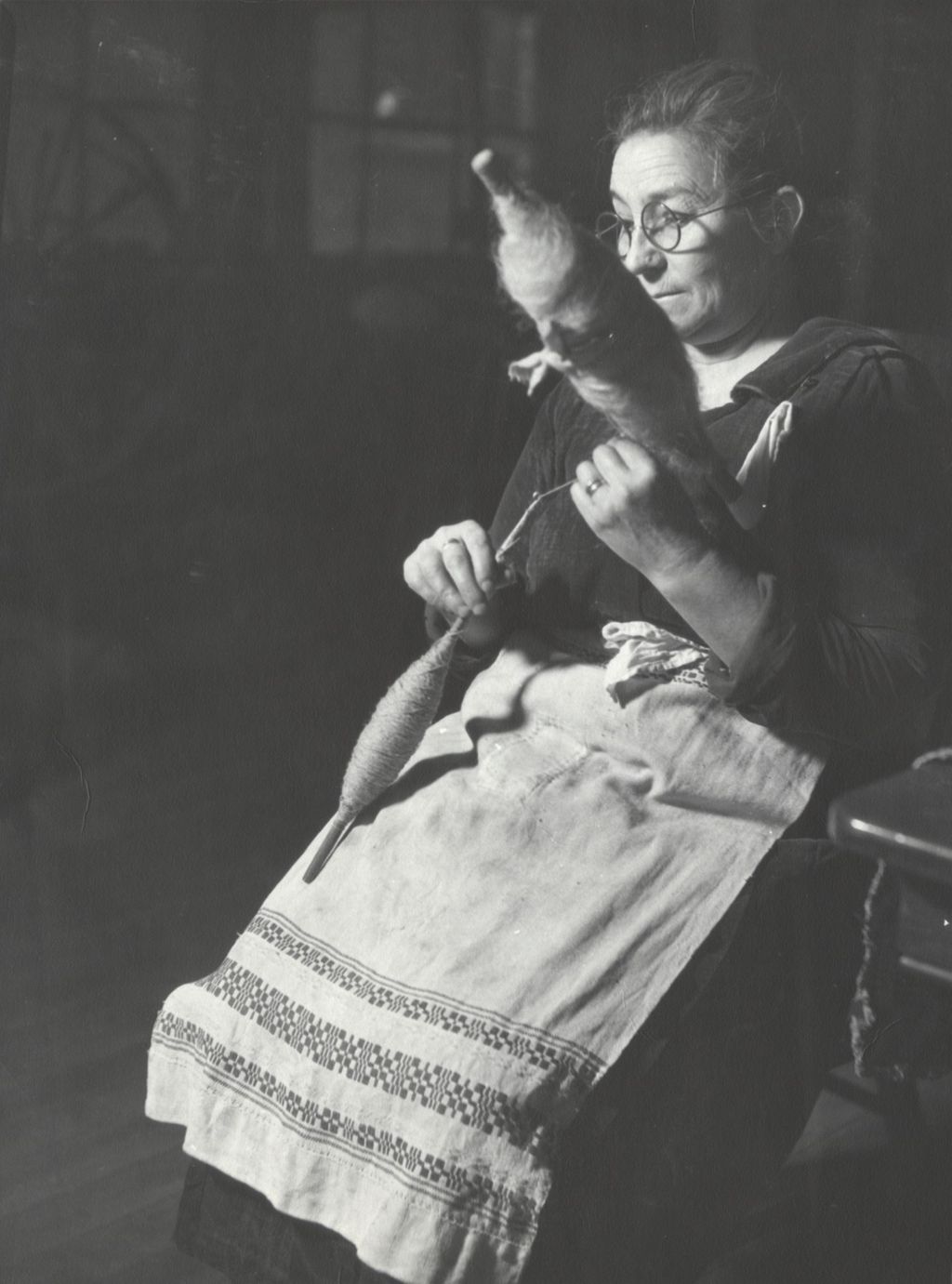 Miniature of Woman demonstrating hand-spinning technique at Hull-House Labor Museum