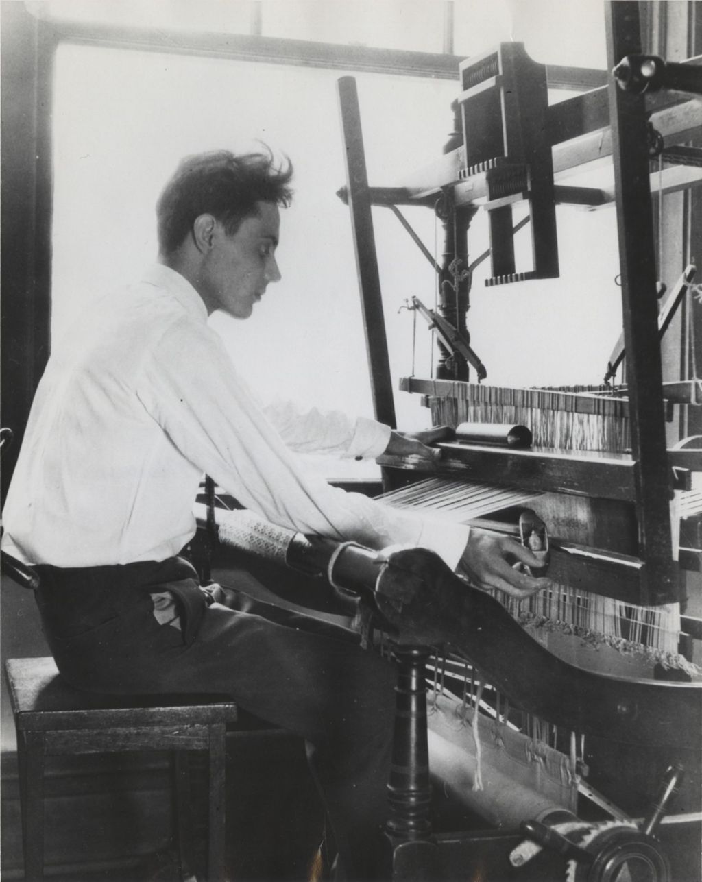 Miniature of Man sitting at a loom at the Hull-House Labor Museum