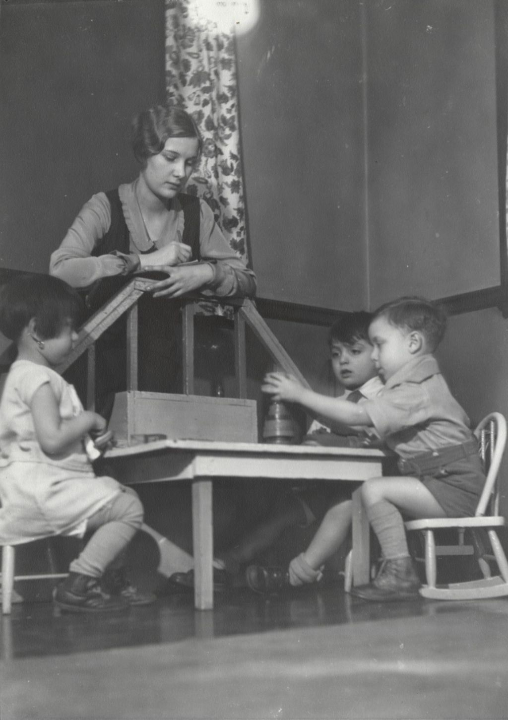Hull-House nursery school student teacher with children