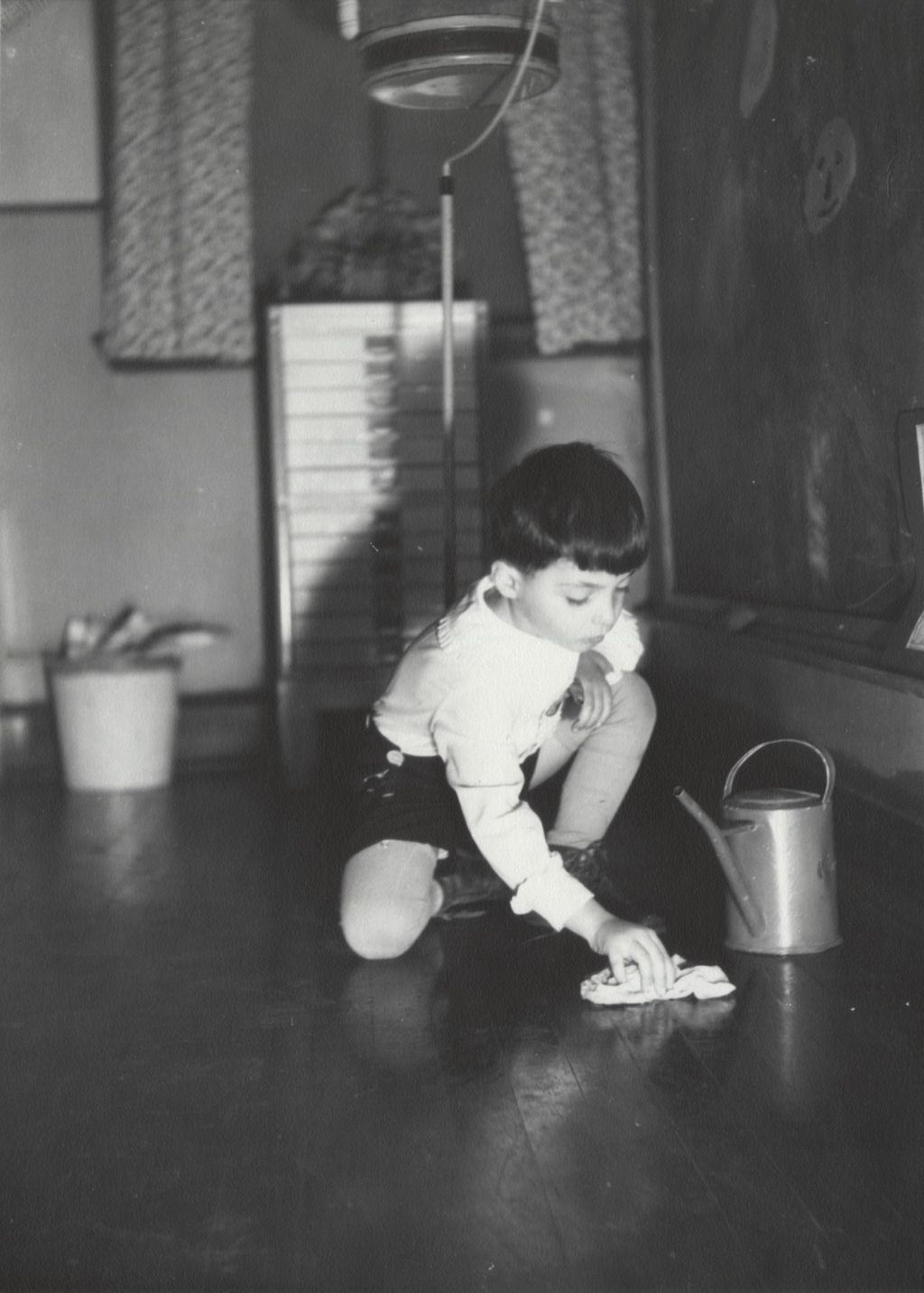 Boy washing floor at Hull-House nursery school