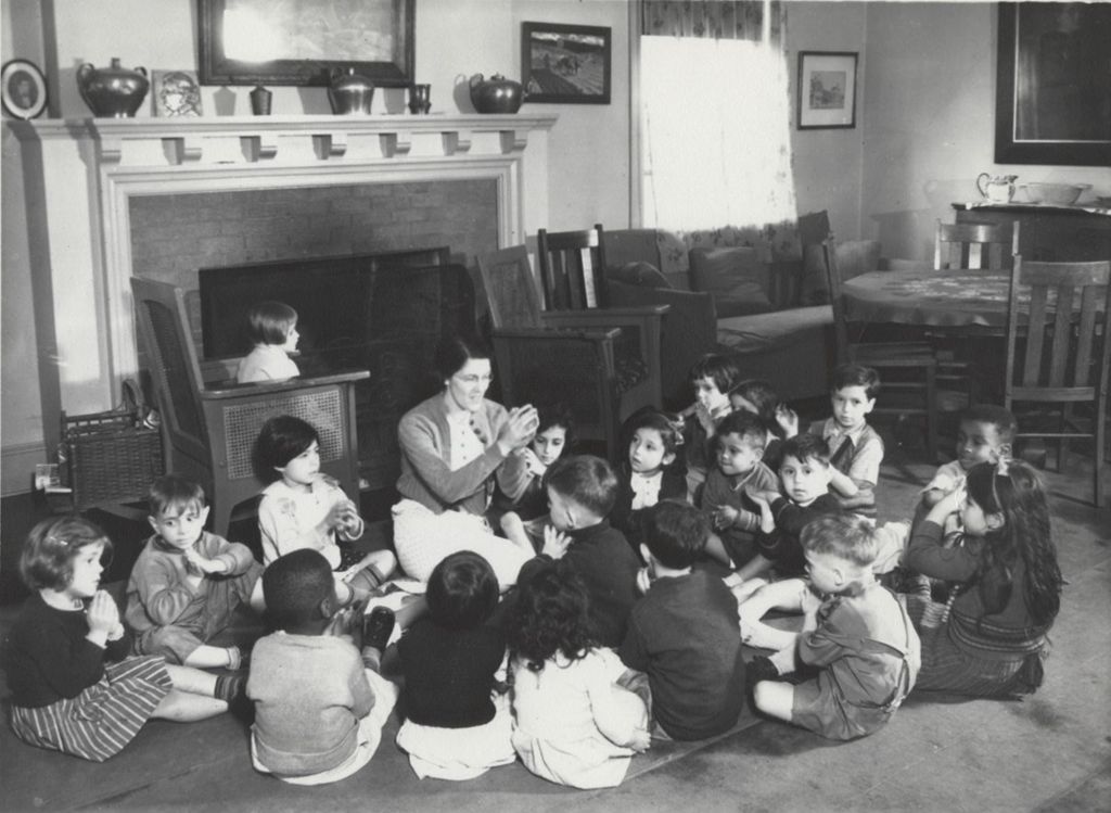 Teacher with large group of young children