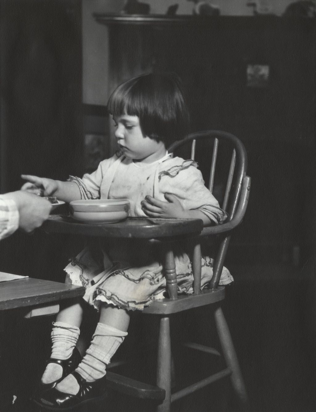 Miniature of Young girl in a high chair