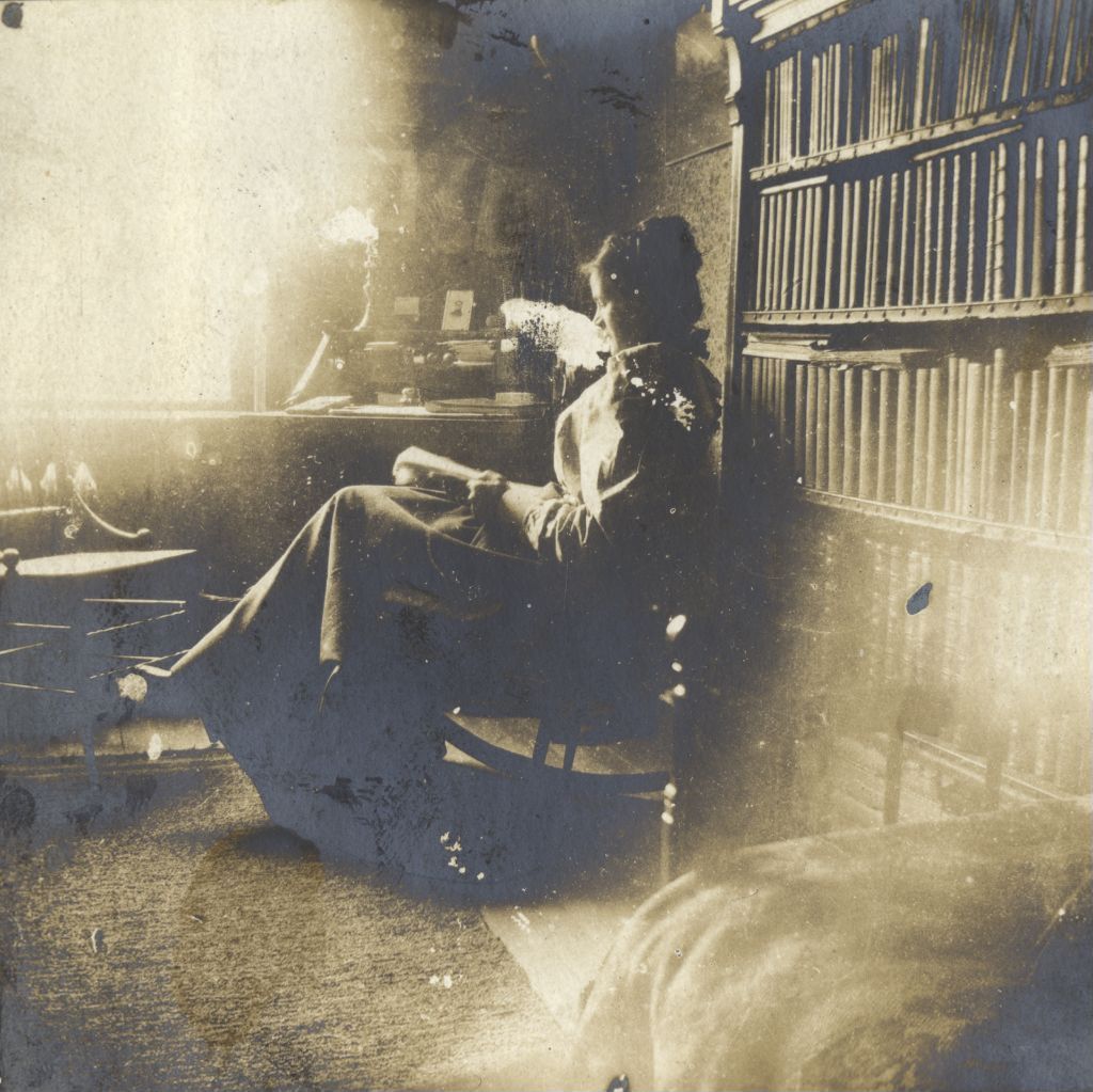 Miniature of Woman reading in rocking chair at Hull-house