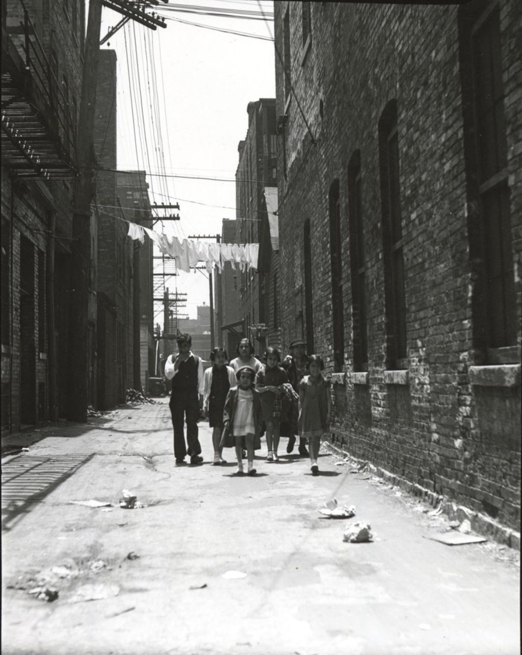 Miniature of Family of seven walking through alley toward Hull-House