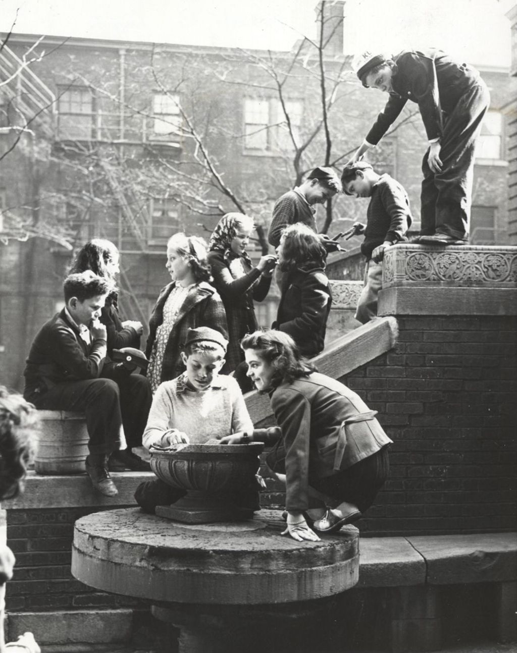 Young people congregating on stairway of Hull-House courtyard terrace