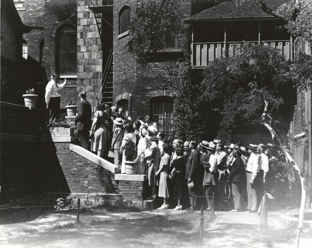 Miniature of Large group in Hull-House courtyard on a tour