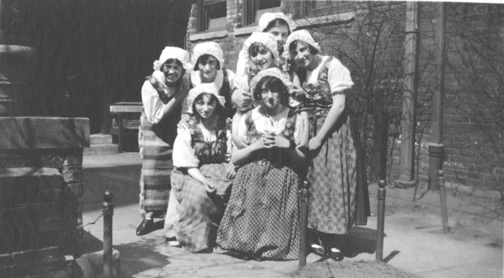 Miniature of Young women in folk costumes posing in courtyard